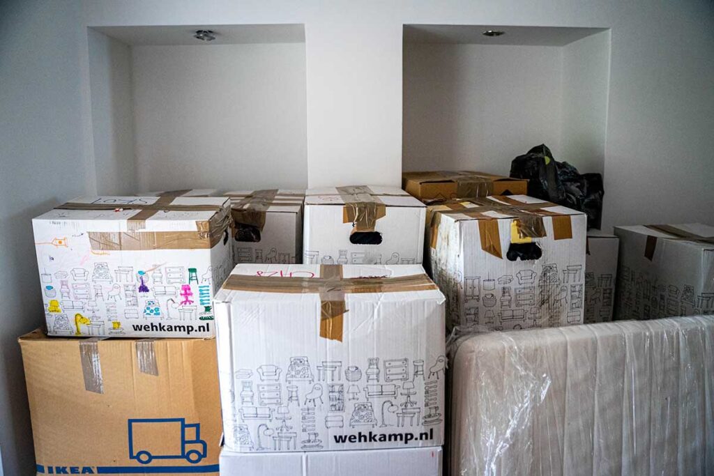 A stack of moving boxes can be overwhelming and contribute to the stress of moving.