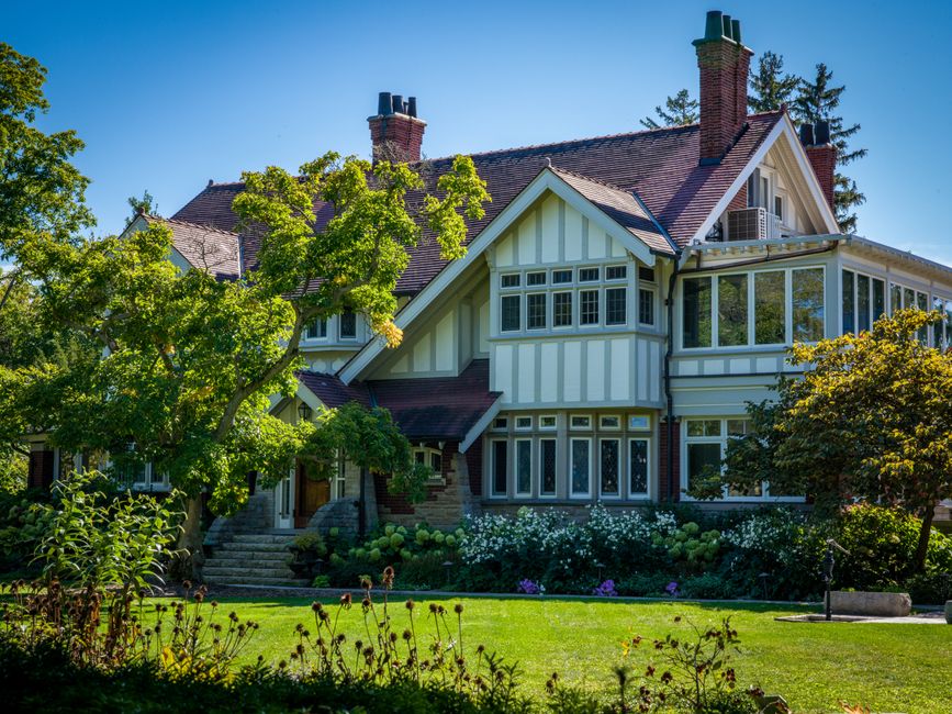 A beautiful, well-maintained Kansas City style home on a bright, sunny day, representing a valuable asset that homeowners work to protect.
